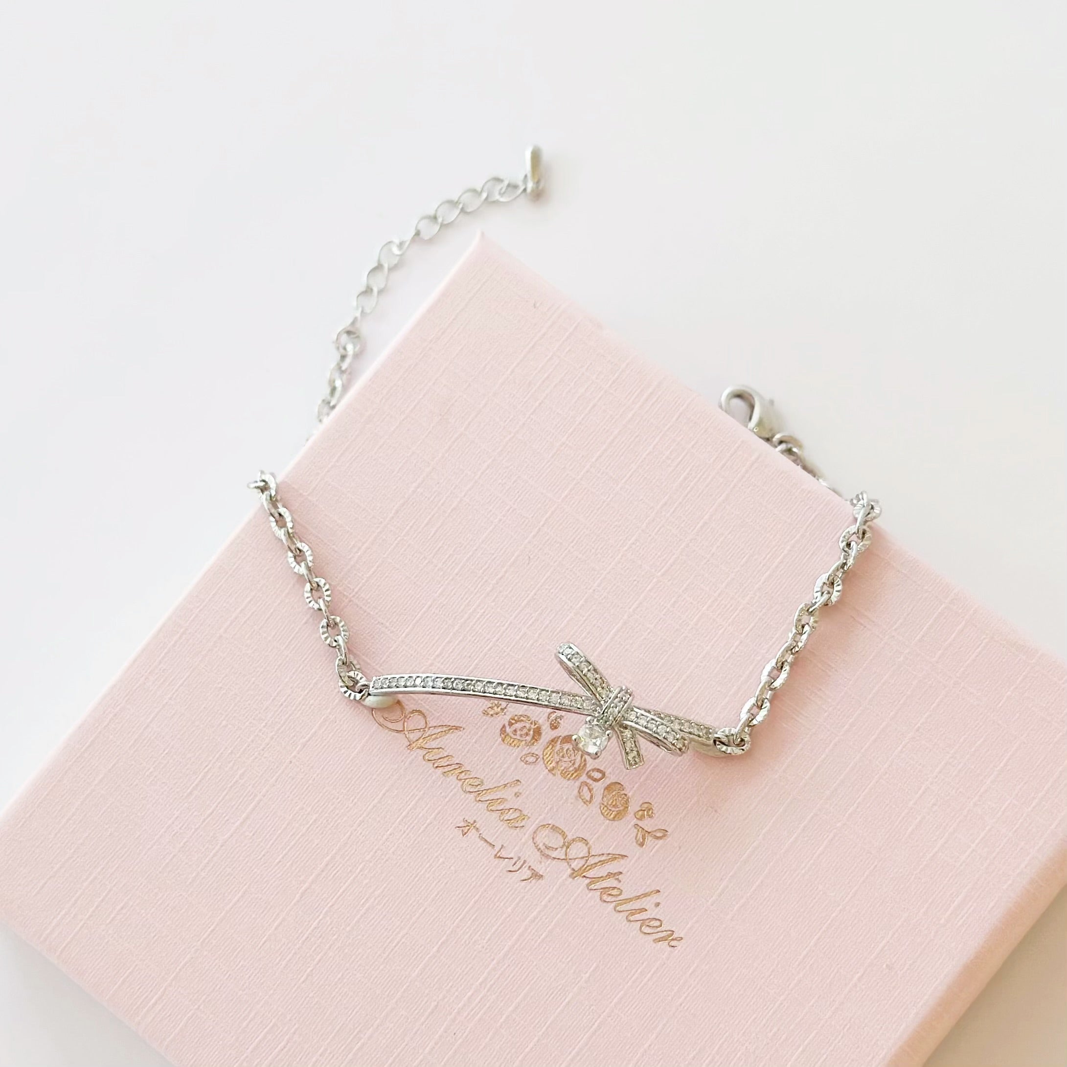 Silver Dear Love Ribbon Bracelet with pavé cubic zirconia bow design, 925 sterling silver rhodium plated, by Aurelia Atelier, IU, perfect crown, kdrama earrings, chanel earrings, ruban, 蝴蝶结耳环，镶嵌密钉立方氧化锆，925纯银镀铑, 